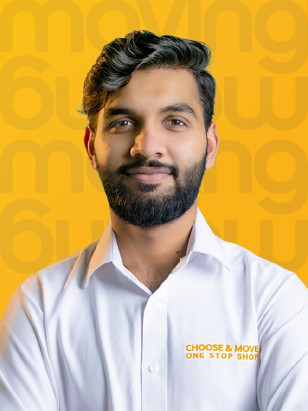 portrait of a smiling man in a white shirt with an orange 'choose & move — one stop shop' logo, against a bright yellow background with large, faint text.